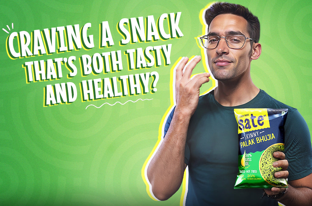 Man holding a pack of Healthy Baked Namkeen - Palak Bhujia by Sate snacks with the tagline 'Craving a Snack That's Both Tasty and Healthy?' on a green background.